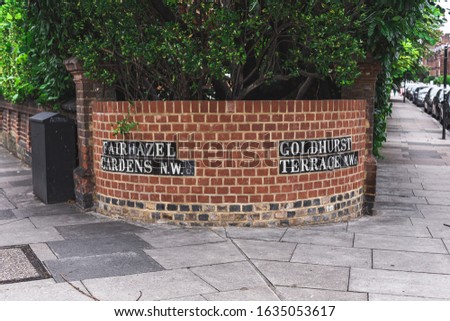 Fairhazel Gardens and Goldhurst Terrace street name signs on their crossroad in London Borough of Camden, London, UK