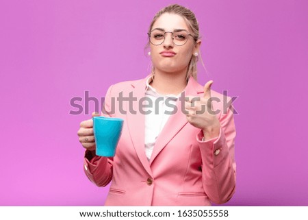 young pretty blonde woman with a coffee cup