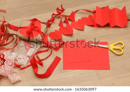 Colorful ribbons, scissors and wrapping paper lie on the table. Gift Wrapping