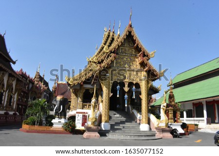 temple complex in Chang Mai Thailand. Dragons gold in the sun.
