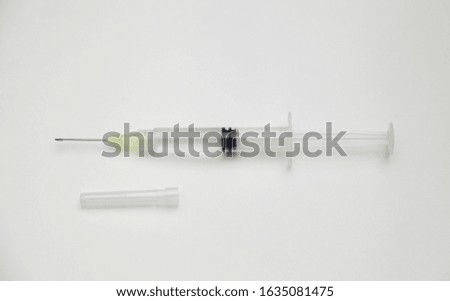 Syringe with cap on white background 