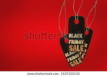 Black friday. Sale tag on the red background Wood Text