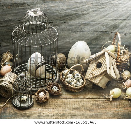 vintage easter decoration with eggs, birdhouse and birdcage. nostalgic style picture with sun beams effect