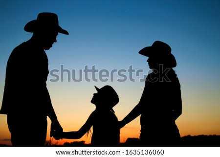 silhouette of a happy pregnant  family with children