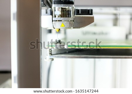 Modern 3D Printer Machine Printing Figure Close-up. Macro Photography of 3D Printing Technology.