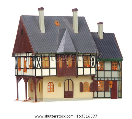 Realistic looking plastic toy house isolated on white