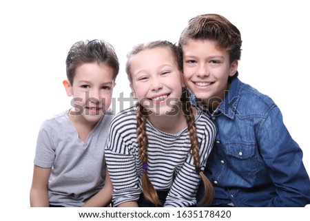 Happy brothers and sister in front of a background