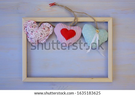 soft hearts in frame on wooden background with copy space. Valentine's day and birthday or wedding concept. 