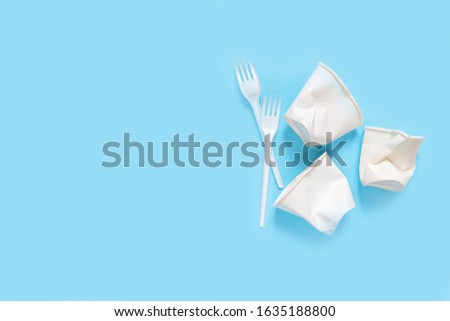 plastic waste, plastic utensils on a blue background. The concept of waste disposal and ecology. Zero waste Flat lay, top view