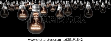 Group of light bulbs going from dark one to a shining one isolated on black background. Concept of Idea, Thinking, Success and Creativity.