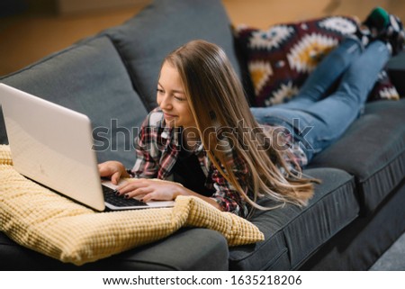 Cute girl using lap top. Little girl surfing internet. 
