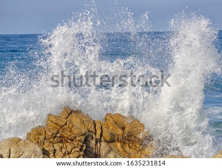 Waves crash on the California coastline, Monterey County, CA.