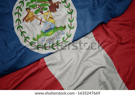 waving colorful flag of peru and national flag of belize. macro