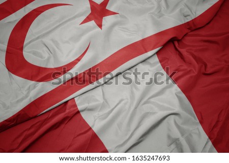 waving colorful flag of peru and national flag of northern cyprus. macro
