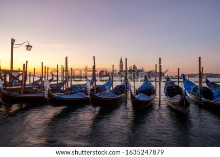 famous gondolas at sunrise. Venice, Italy. picture with long exposure
