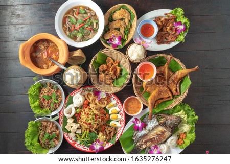 mixed thai isan food on black table Royalty-Free Stock Photo #1635276247