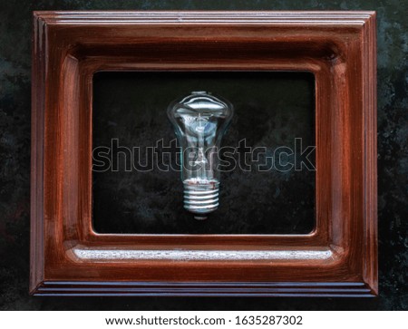 lamp in the frame. light bulb sewn into the picture. idea concept
