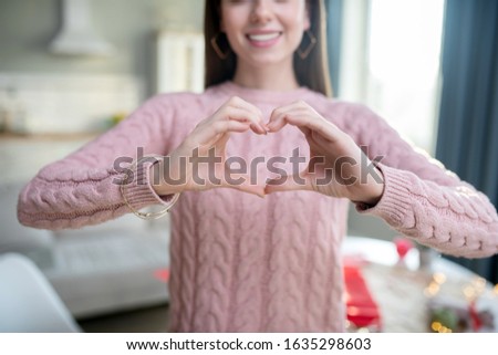 Heart sign. Close up picture of a girl making a heart sign