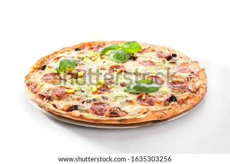 Pizza with marbled beef, ham, salami and chorrizo on metal tray in italy pizzeria isolated. Traditional italian meet pizza with cooked veal, mozzarella and basil, delicious fast food closeup