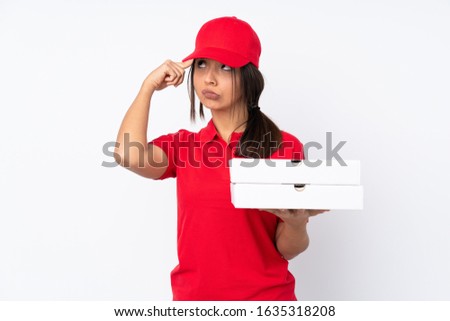 Young Pizza delivery girl over isolated white background making the gesture of madness putting finger on the head
