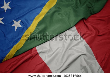 waving colorful flag of peru and national flag of Solomon Islands . macro