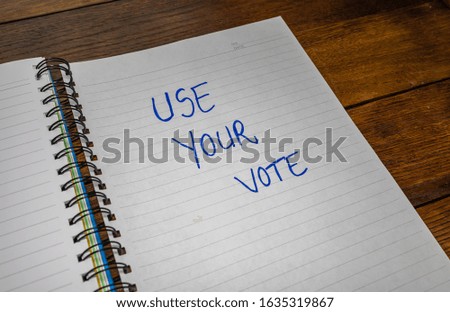 Use your vote handwriting  text on paper political message. Political text on office agenda. Concept of democracy voting  politics and copy space.