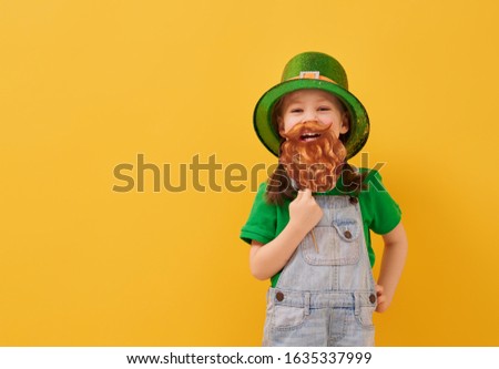 The cute girl in leprechaun hat for a Saint Patrick's Day.                               