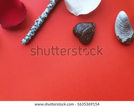 Valentines Day background. Rose, rose petals,chocolate,ribbon and straws rope beautiful. Isolated on pastel red backgrounds. Valentines day concept.View from above. There is a middle area on red floor