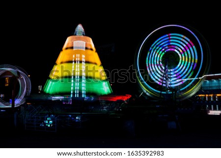 A general view of a long exposure shot of mechanical games in an amusement park