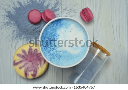 blue matcha in a white cup on white wooden table