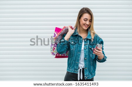 Beautiful woman using mobile phone during shopping  stock photo