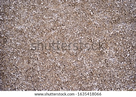 Texture of a part of the wall made of concrete with stone chips.