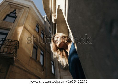 Portrait of a young woman traveler on the background of old buildings.