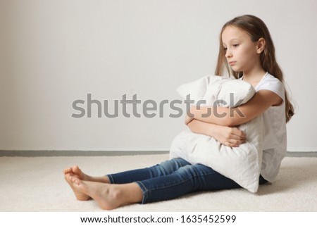 Lonely sad girl at home. The concept of loneliness. saddened alarmed child alone at home.
 Royalty-Free Stock Photo #1635452599
