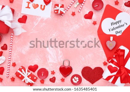 Valentine hearts with candles, gift boxes, envelope and text Happy Valentines Day on coral background