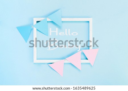 Greeting card for a newborn baby. Set of children's accessories on a pastel blue background. Template for text in a frame.