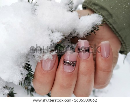 body color nails and black stripes on two nails. Stylish fashionable woman's manicure. Nail polish. Artistic manicure. Modern style. Winter manicure.