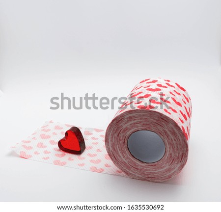 toilet paper with hearts on a white background and a red heart