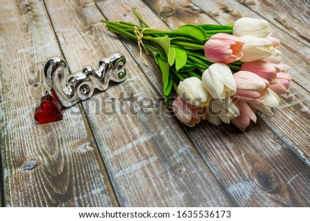 tulips on a beautiful background with the inscription love