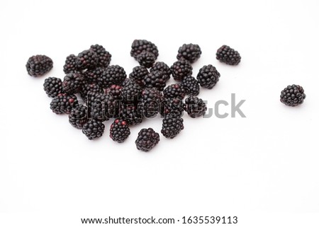 on a white background lie the berries of raspberry with drops of water
