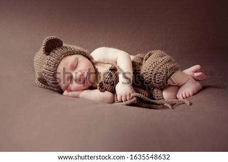 Newborn baby session. Child baby portrait . Sweet tot little child on a blanket background. Newborn with teddy bear Royalty-Free Stock Photo #1635548632