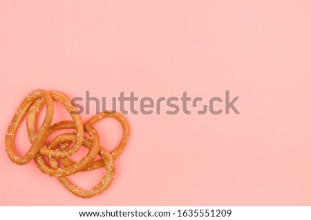 Large bagels on a pink background. Dessert. Still life with breadcrumbs.