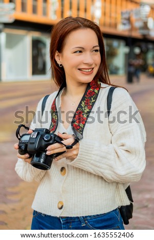 young woman with reflex camera