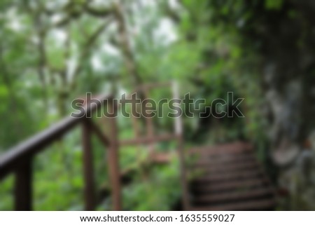 Abstract blurred slide background. Pathway with stairs in the forest. 