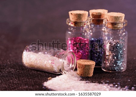 Glass bottles photographed in the studio with colored foils before the flashes                           