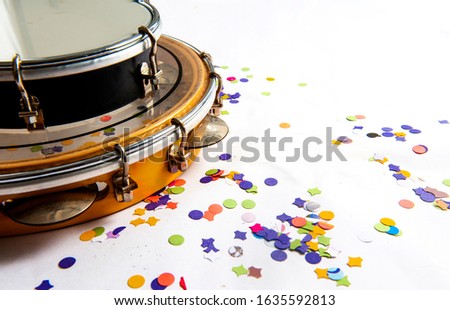 Tamborim, tambourine, traditional samba instruments, used in the Brazilian carnival. White background, paper confetti. Seen from above. Space for text. Horizontal. Royalty-Free Stock Photo #1635592813