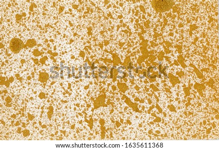 Golden drops of paint on a white paper background. Web banner.