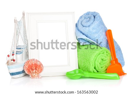 Photo frame with beach towels and toys. Isolated on white background