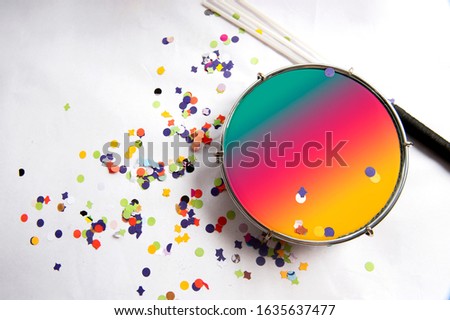 Traditional samba instrument, tambourine is used in the Brazilian carnival. White background, paper confetti. Seen from above. Space for text. Horizontal. Royalty-Free Stock Photo #1635637477