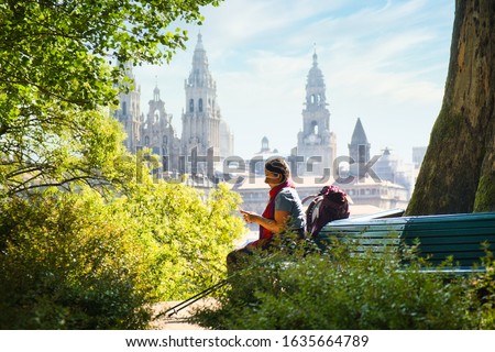 Tourist Woman On Pilgrimage At Santiago De Compostela With Phone Royalty-Free Stock Photo #1635664789